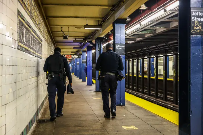 NYPD policemen are seen at subway station at Brooklyn in October. Felony crime on the subways remains high compared to the same time last year.